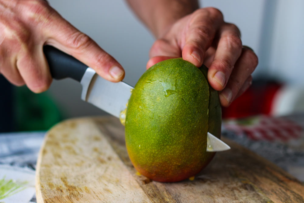 cutting mango cheeks from the pit